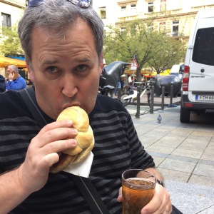 Man enjoys sausage and cider